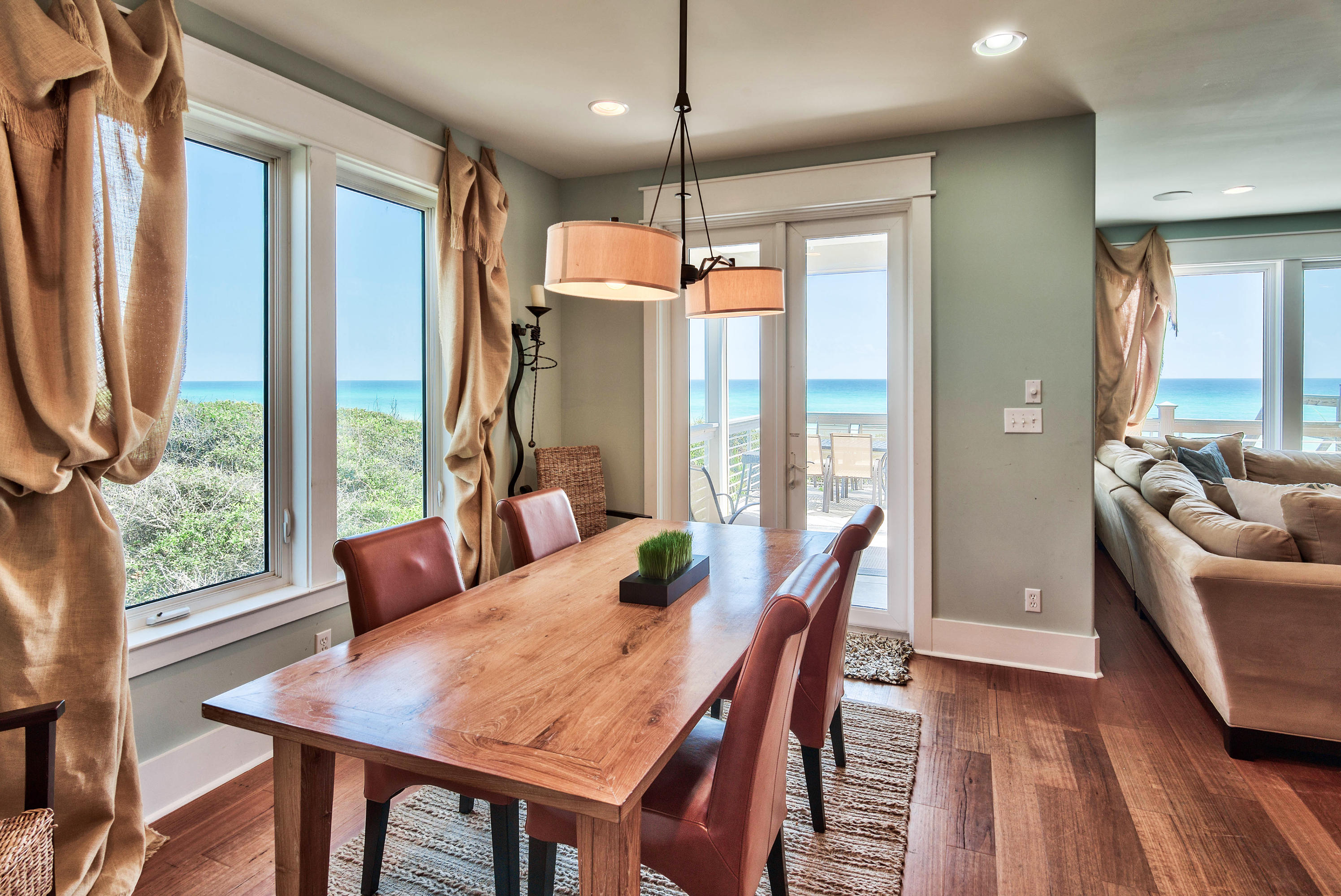 179 Pelican Circle Seacrest, FL 32461 - Photo 27 of 94 a dining room with furniture a chandelier and wooden floor