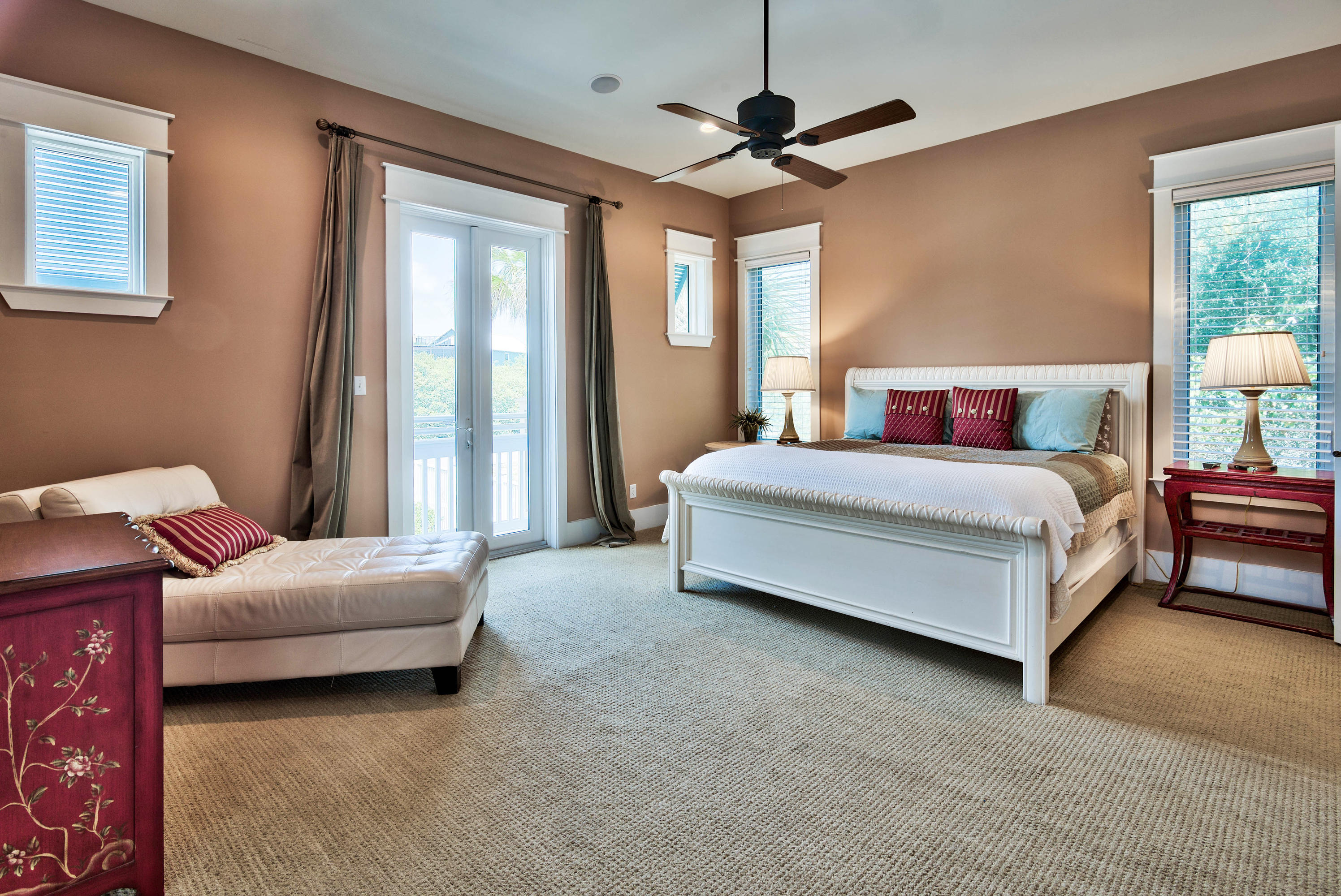 179 Pelican Circle Seacrest, FL 32461 - Photo 40 of 94 a spacious bedroom with a bed chandelier and a window