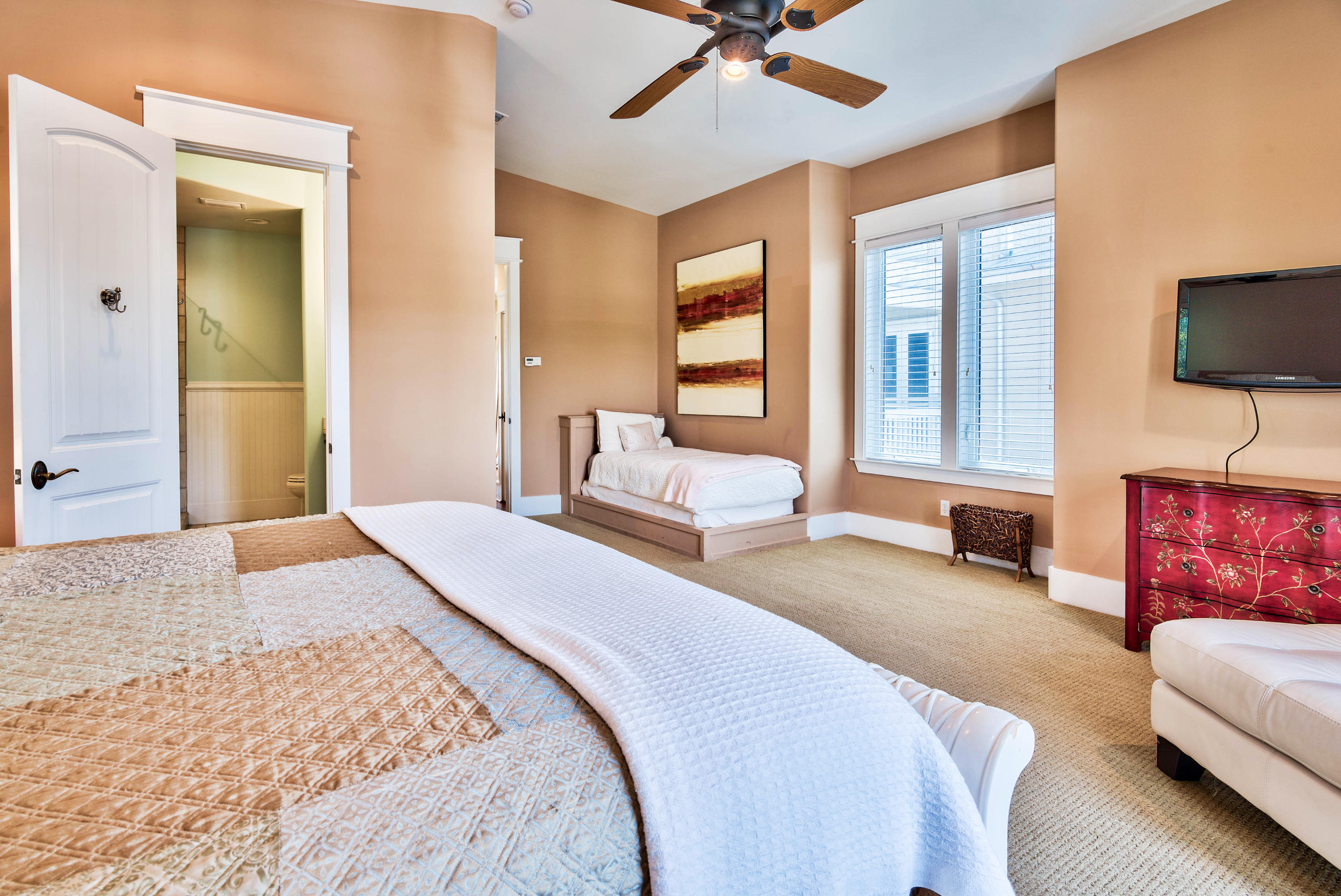 179 Pelican Circle Seacrest, FL 32461 - Photo 41 of 94 a bedroom with a balcony a bed and a couch