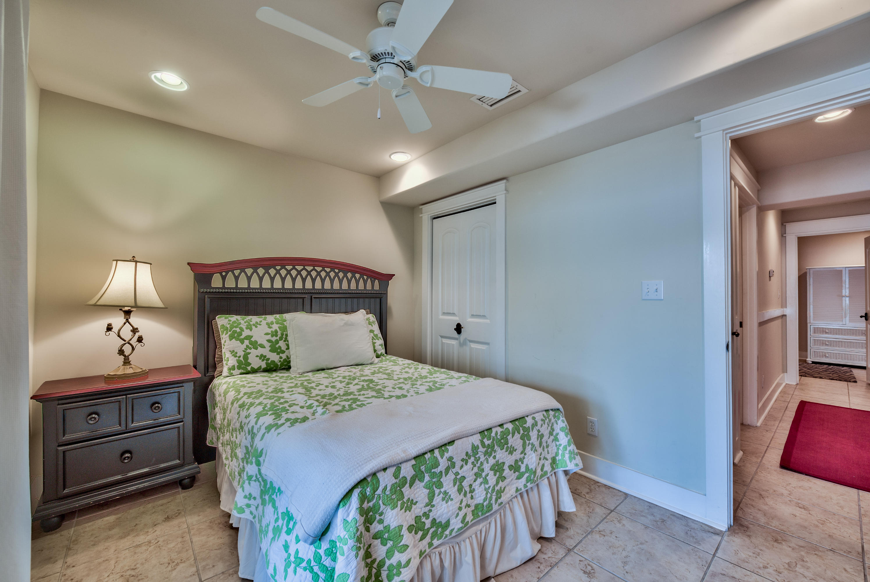 179 Pelican Circle Seacrest, FL 32461 - Photo 45 of 94 a bedroom with a bed and a chandelier
