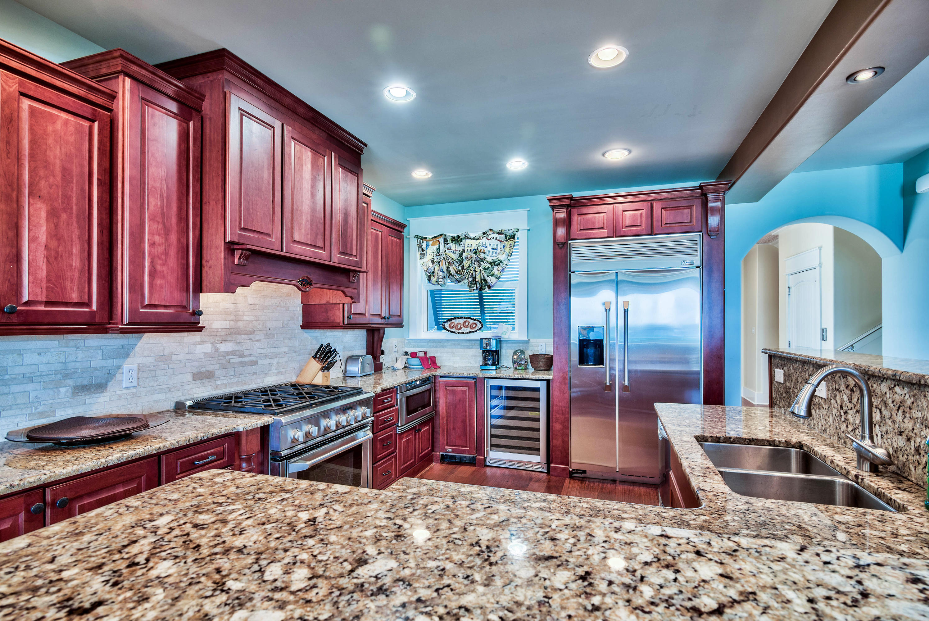 179 Pelican Circle Seacrest, FL 32461 - Photo 6 of 94 a kitchen with stainless steel appliances granite countertop a stove a sink and a microwave