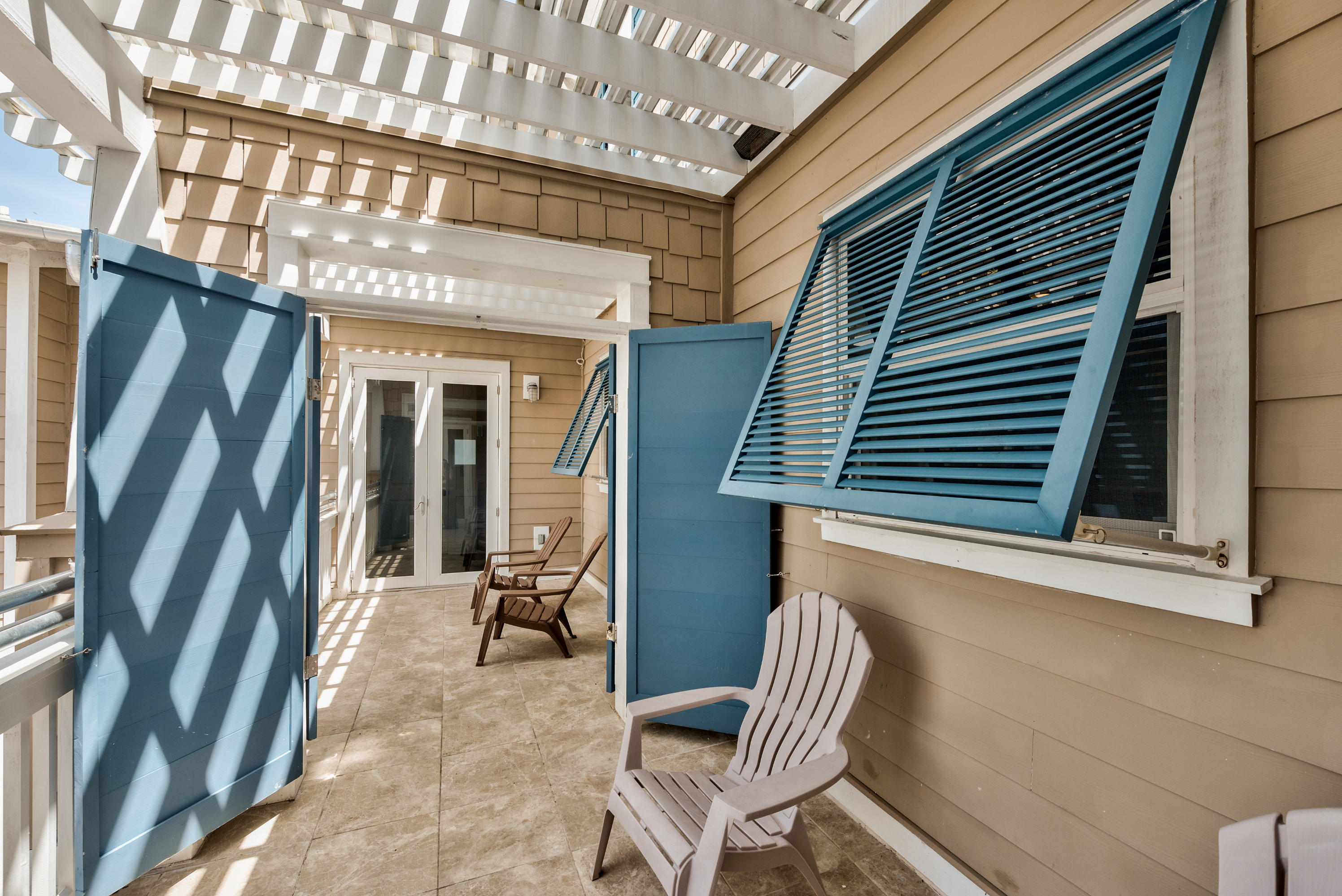 179 Pelican Circle Seacrest, FL 32461 - Photo 55 of 94 a view of patio with a table and chairs and floor to ceiling window with wooden floor