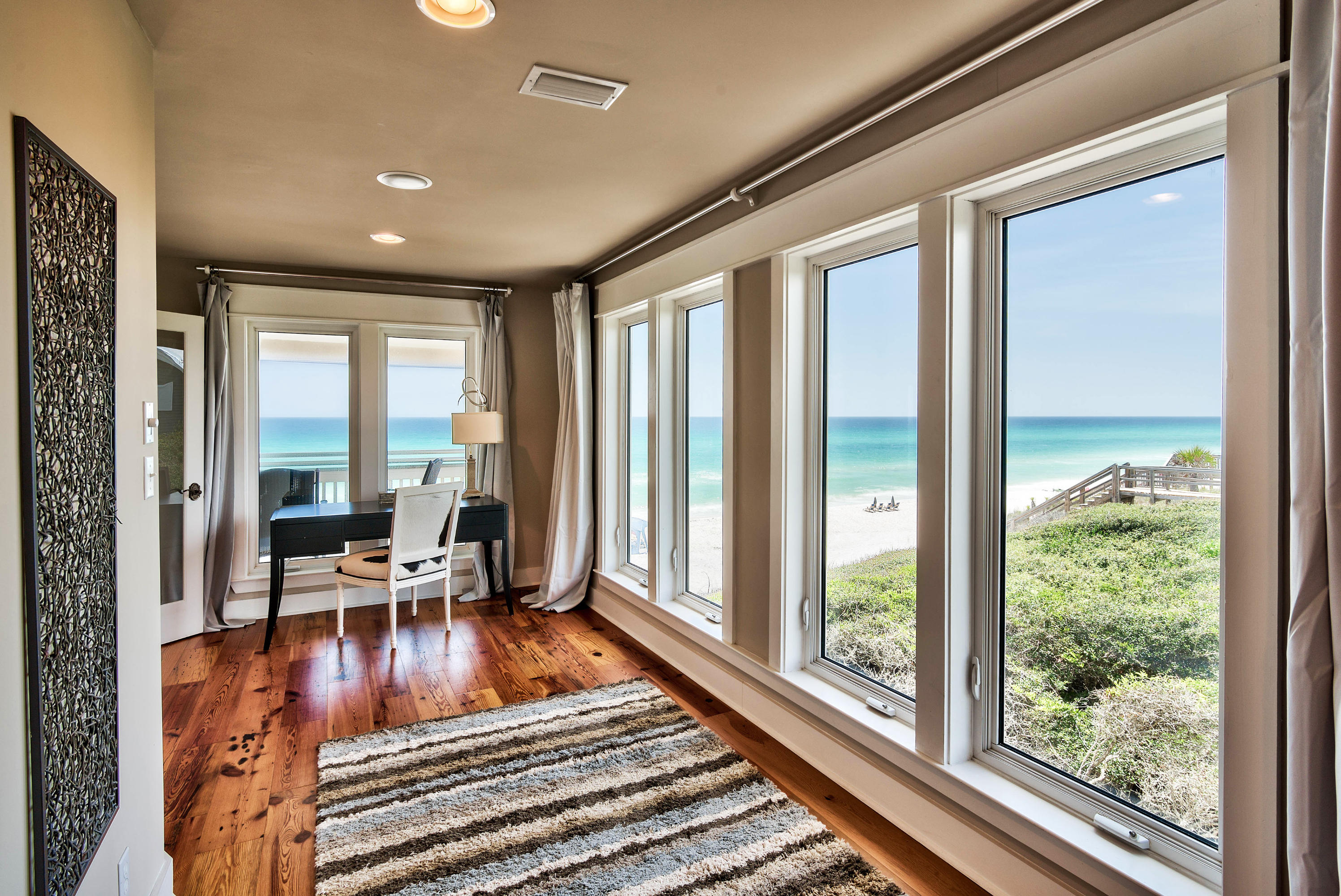 179 Pelican Circle Seacrest, FL 32461 - Photo 7 of 94 a living room with furniture floor to ceiling windows and floor to ceiling window