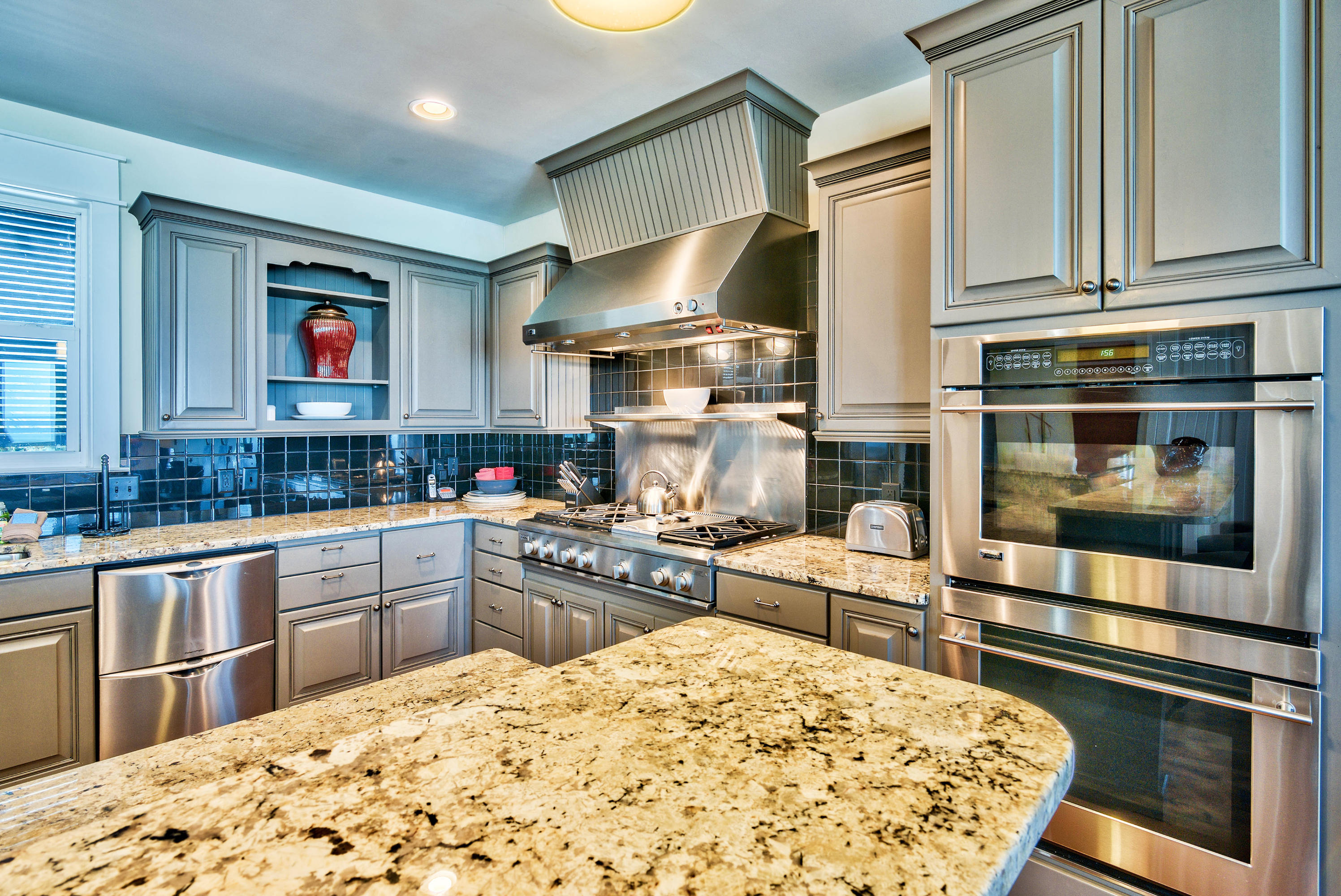179 Pelican Circle Seacrest, FL 32461 - Photo 63 of 94 a kitchen with stainless steel appliances granite countertop a stove top oven a sink and dishwasher a oven with wooden cabinets