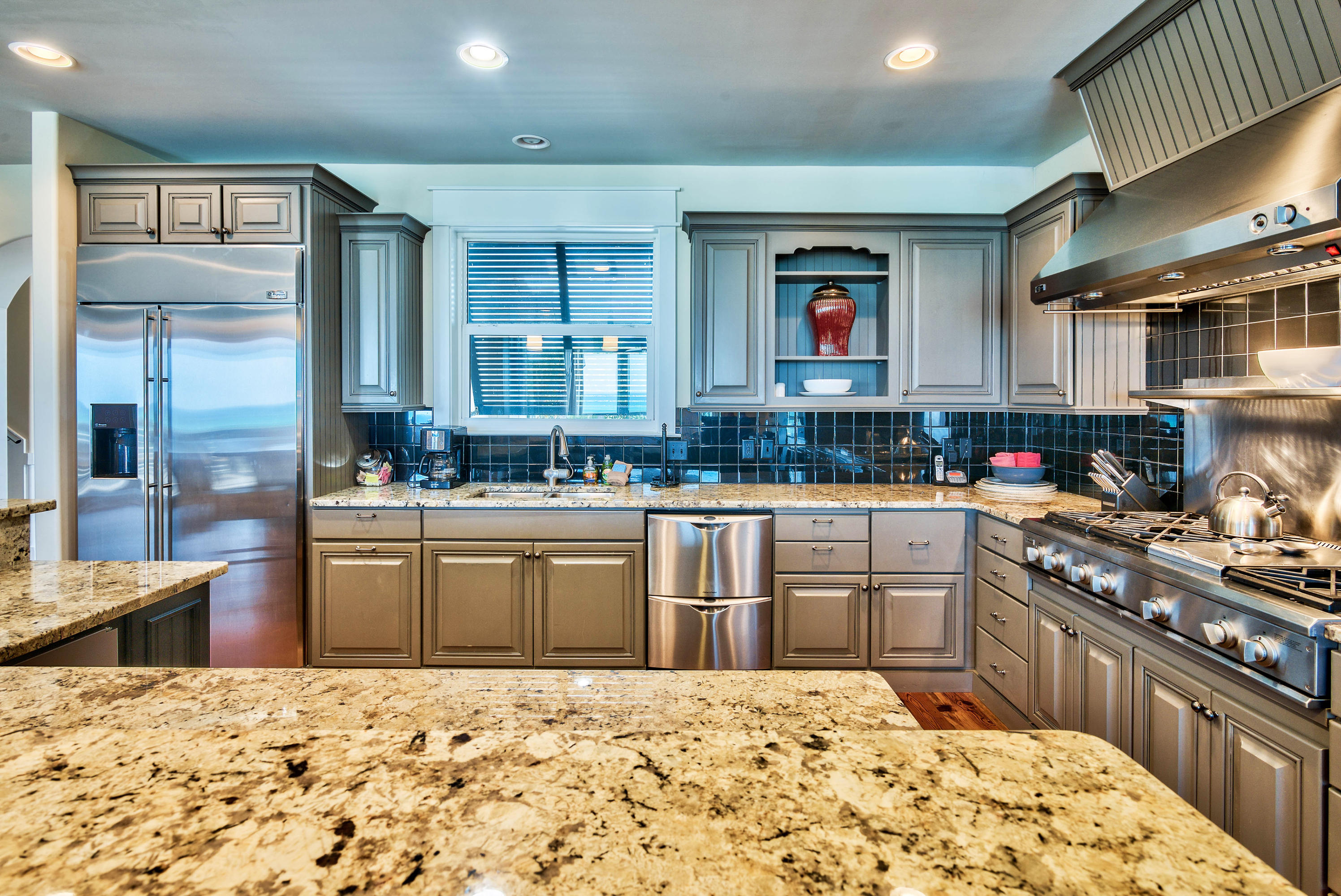 179 Pelican Circle Seacrest, FL 32461 - Photo 64 of 94 a kitchen with stainless steel appliances kitchen island granite countertop a sink stove and cabinets