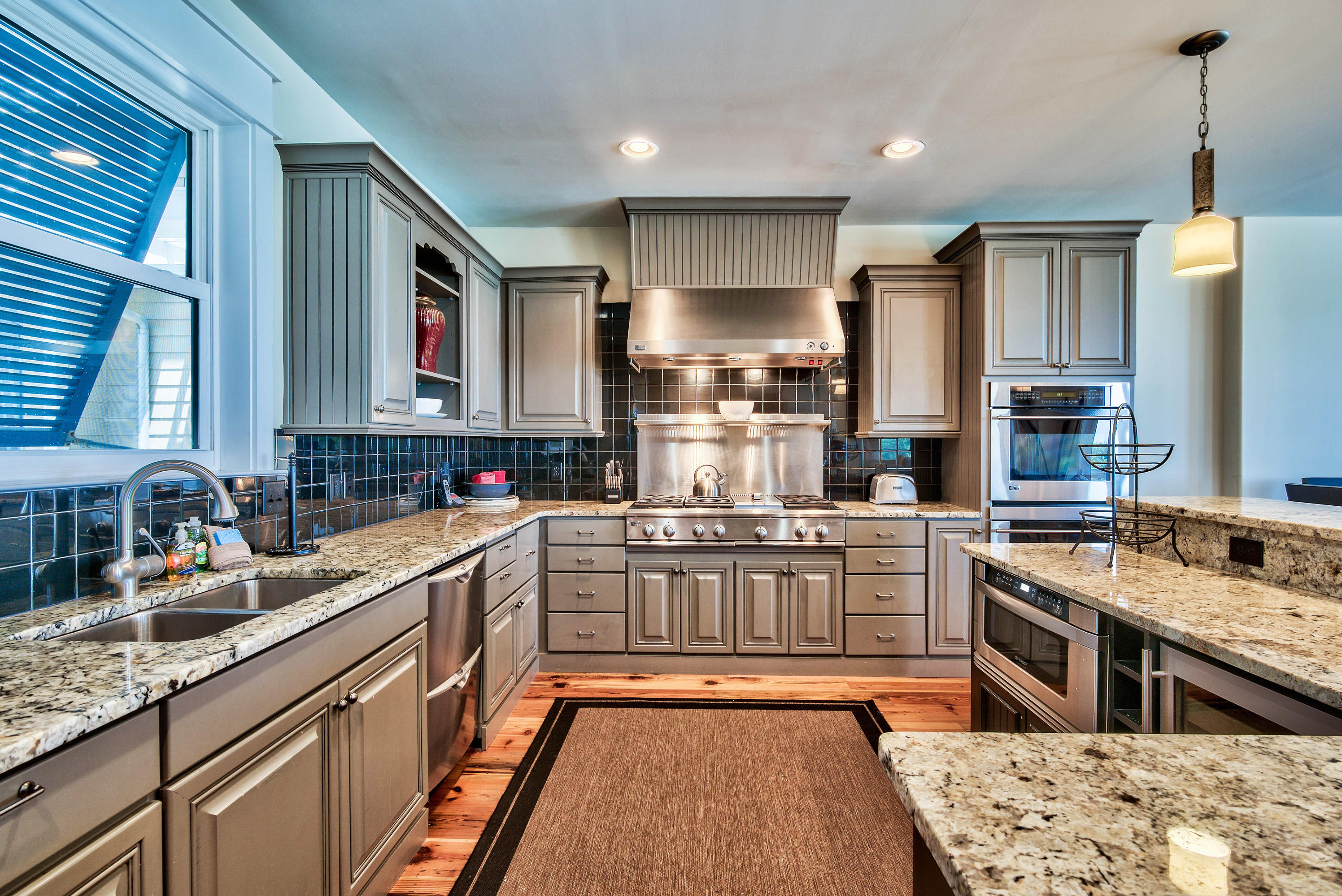 179 Pelican Circle Seacrest, FL 32461 - Photo 65 of 94 a kitchen with stainless steel appliances granite countertop a sink stove and refrigerator