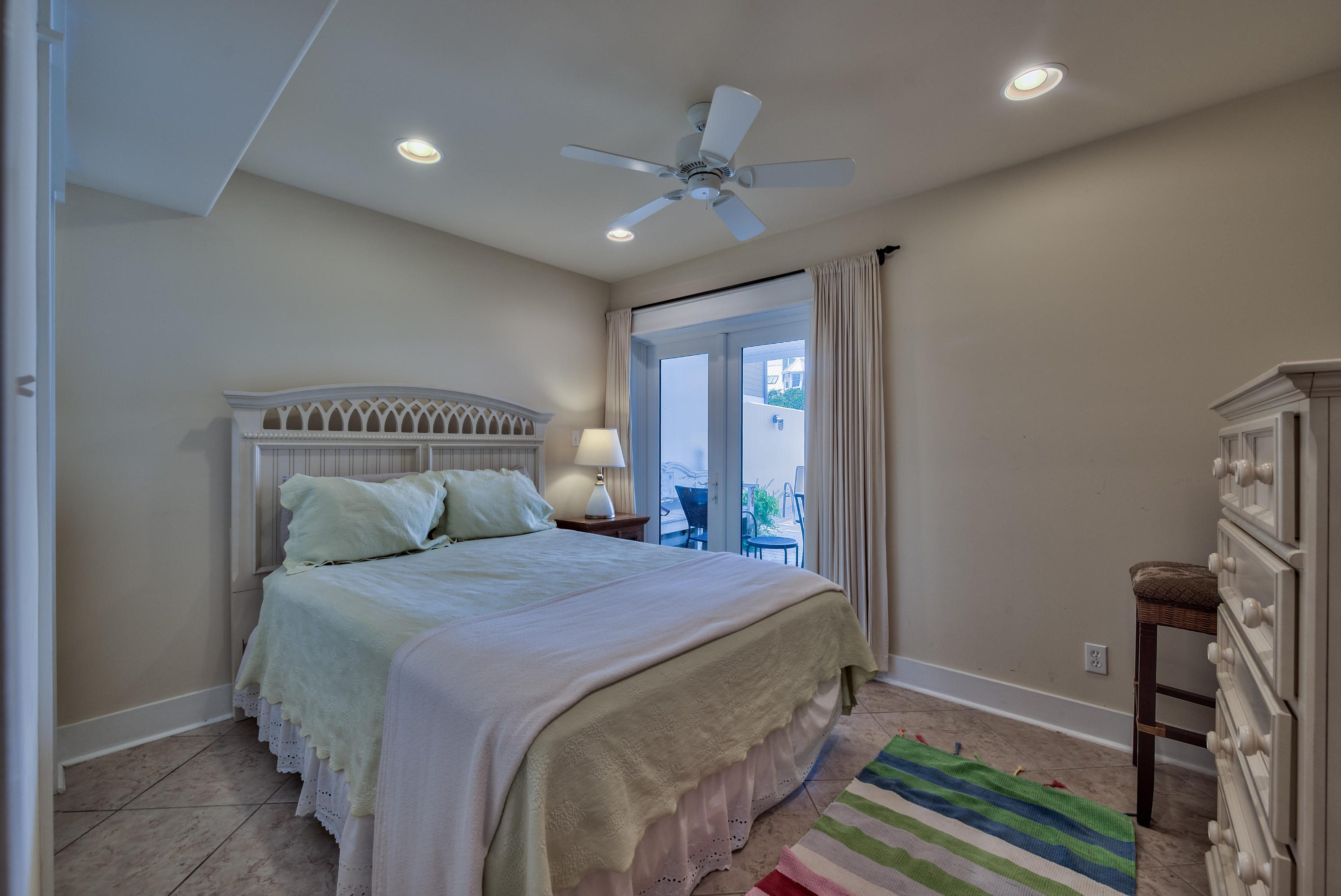 179 Pelican Circle Seacrest, FL 32461 - Photo 75 of 94 a bedroom with a large bed and a chandelier