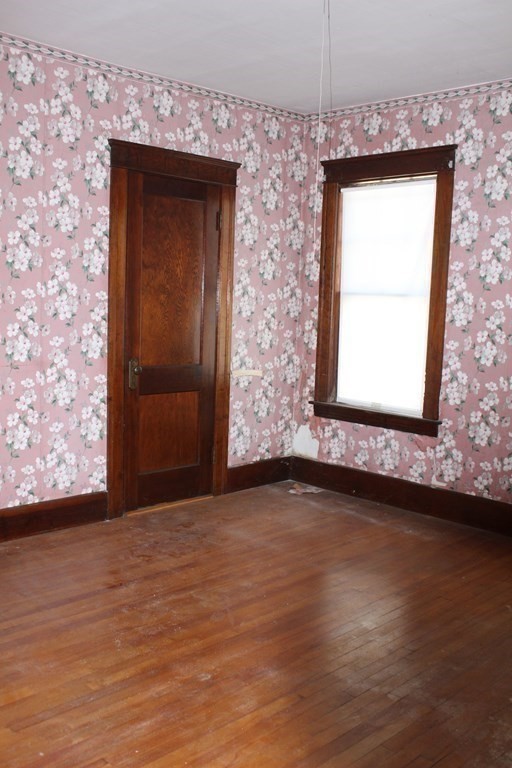 113 Perry Avenue Worcester, MA 01610 - Photo 10 of 16 an empty room with wooden floor and windows