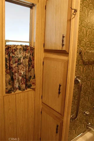 a view of a bathroom with a window and a shower curtain