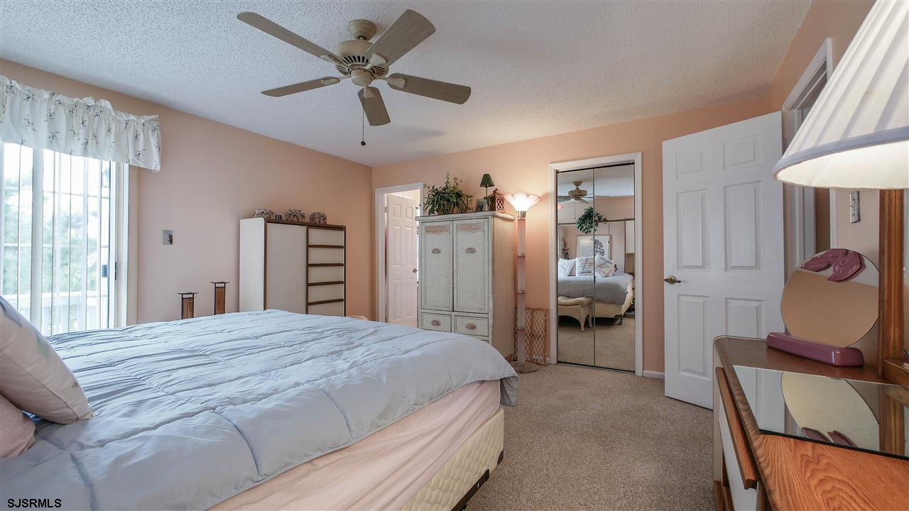 11 Sailfish Drive Brigantine, NJ 08203 - Photo 15 of 23 a bedroom with a bed and a chair