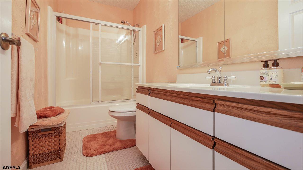 11 Sailfish Drive Brigantine, NJ 08203 - Photo 16 of 23 a bathroom with a sink a toilet and shower