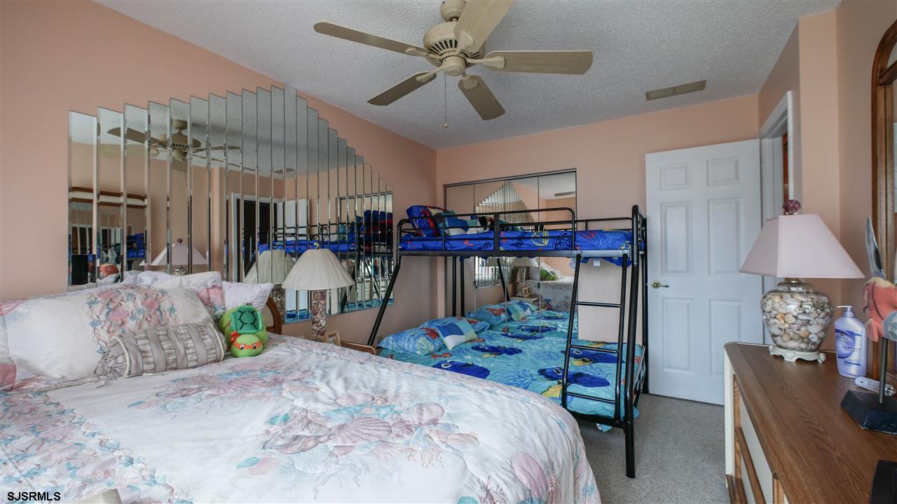 11 Sailfish Drive Brigantine, NJ 08203 - Photo 17 of 23 a bed room with a bed mirror and a couch