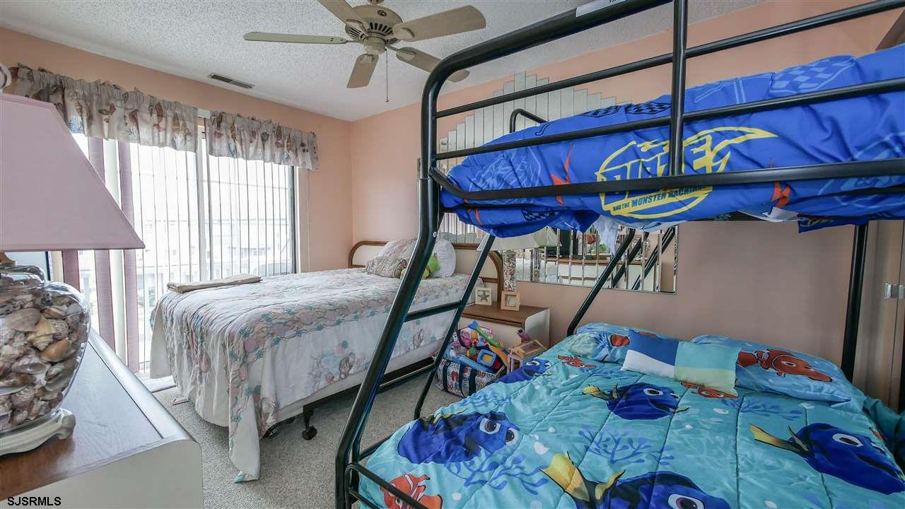 11 Sailfish Drive Brigantine, NJ 08203 - Photo 18 of 23 a bedroom with a bed a dresser and the window