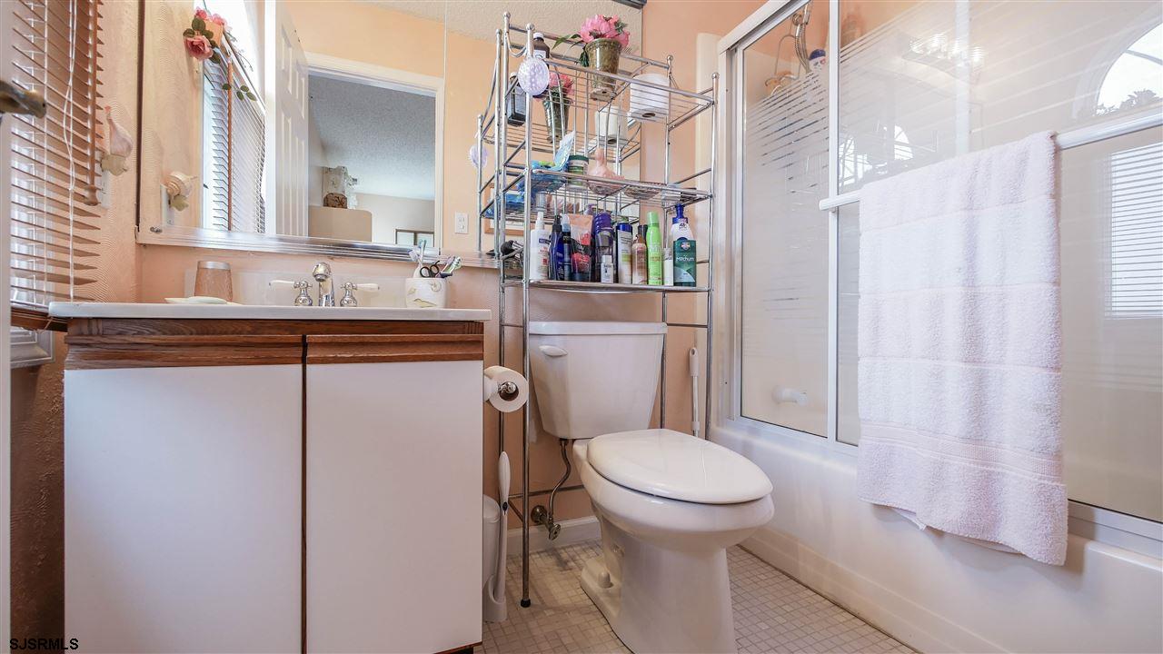 11 Sailfish Drive Brigantine, NJ 08203 - Photo 20 of 23 a bathroom with a sink a toilet and a mirror