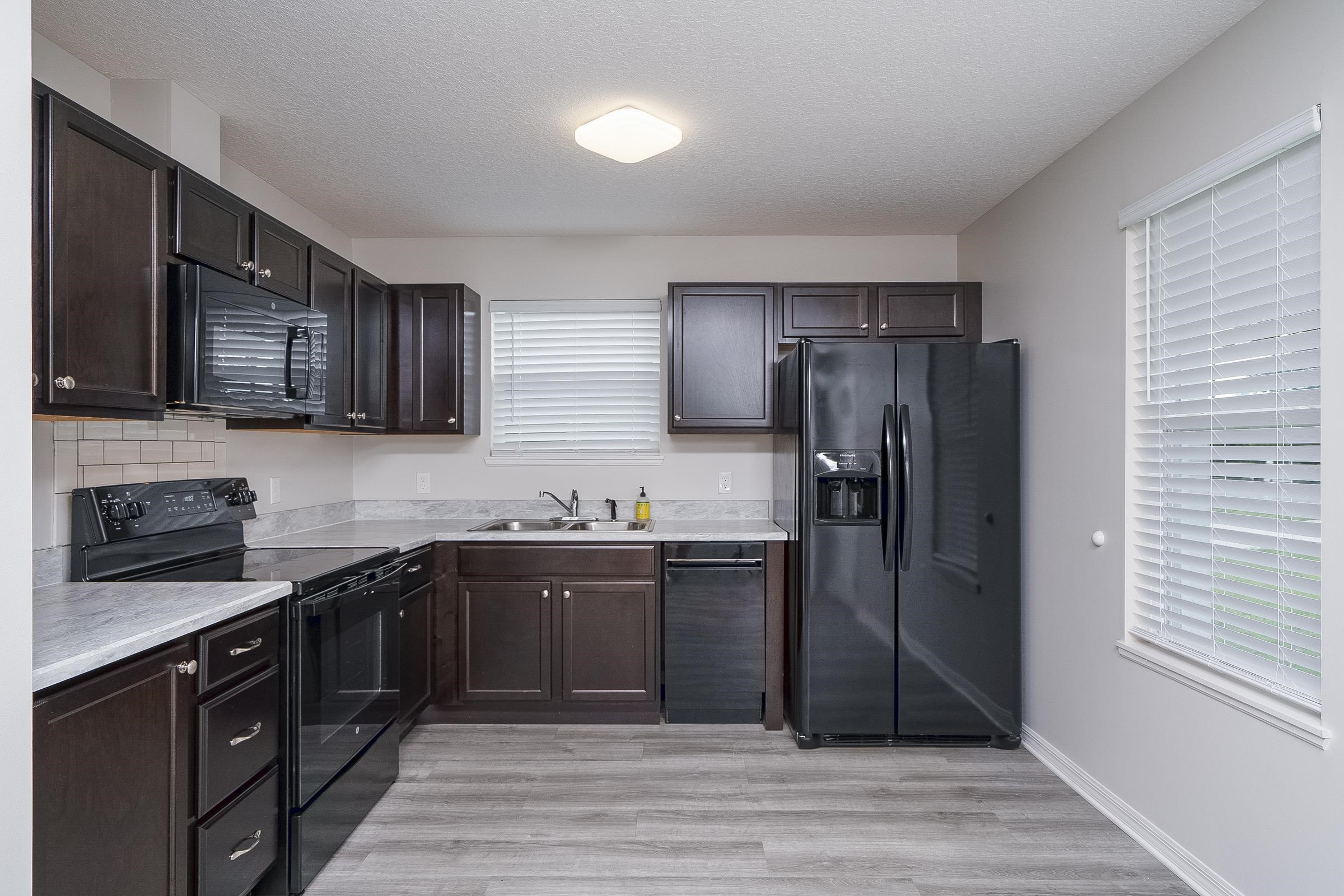 874 Ervin Street St. Augustine, FL 32084 - Photo 13 of 29 a kitchen with stainless steel appliances granite countertop a refrigerator and a stove top oven
