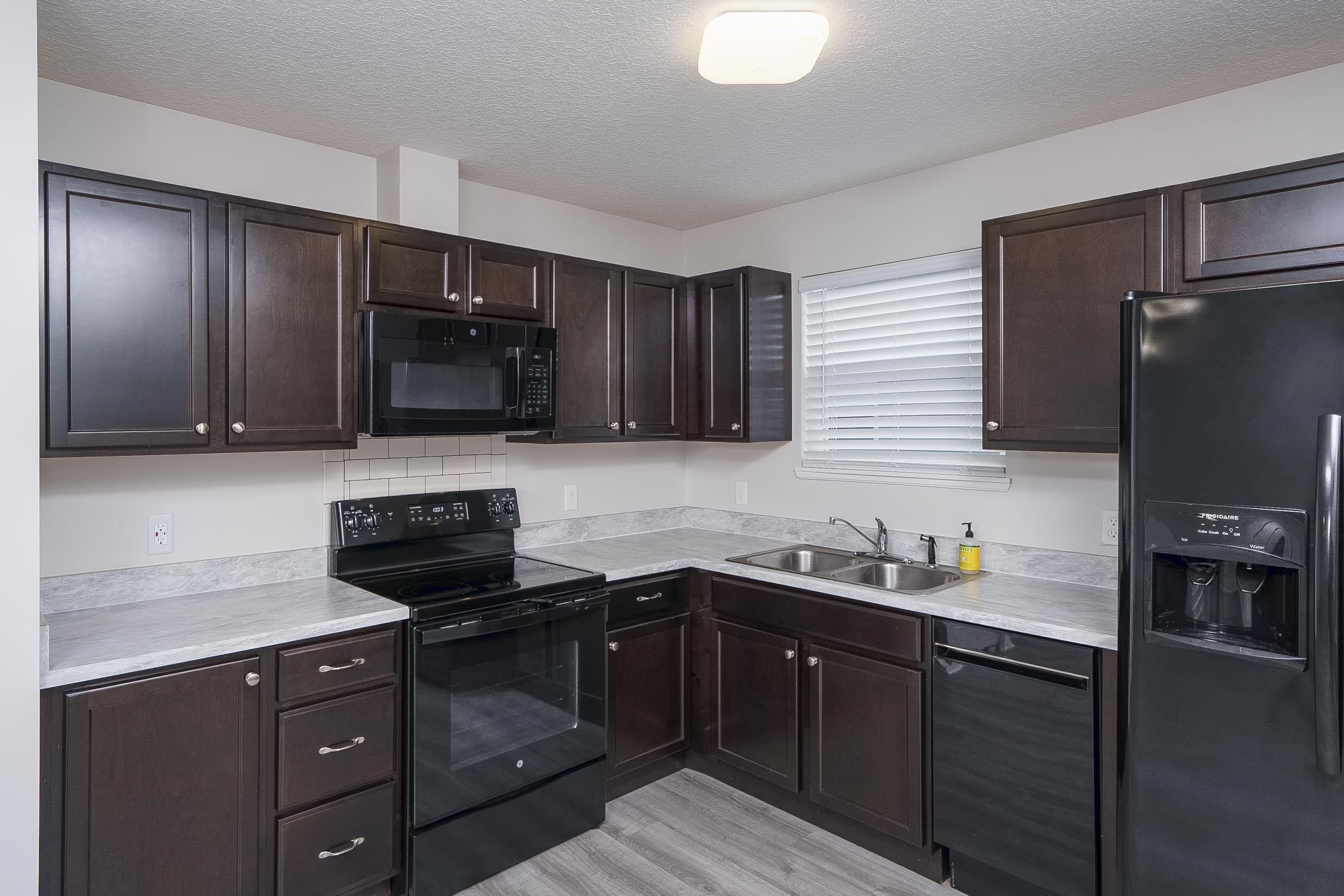 874 Ervin Street St. Augustine, FL 32084 - Photo 14 of 29 a kitchen with stainless steel appliances granite countertop a sink stove and refrigerator