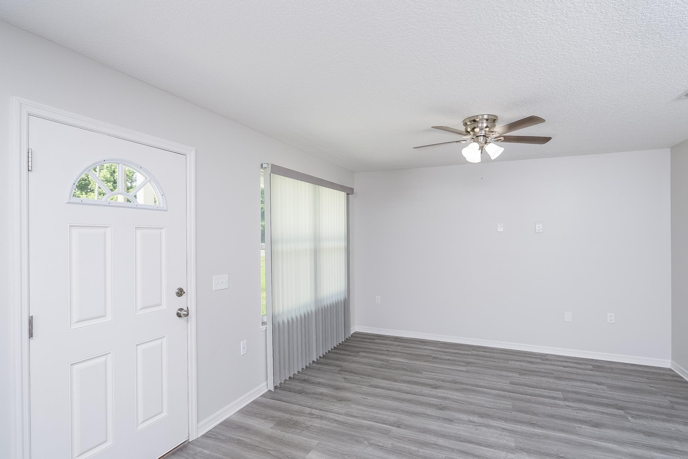 874 Ervin Street St. Augustine, FL 32084 - Photo 16 of 29 wooden floor in an empty room with a window