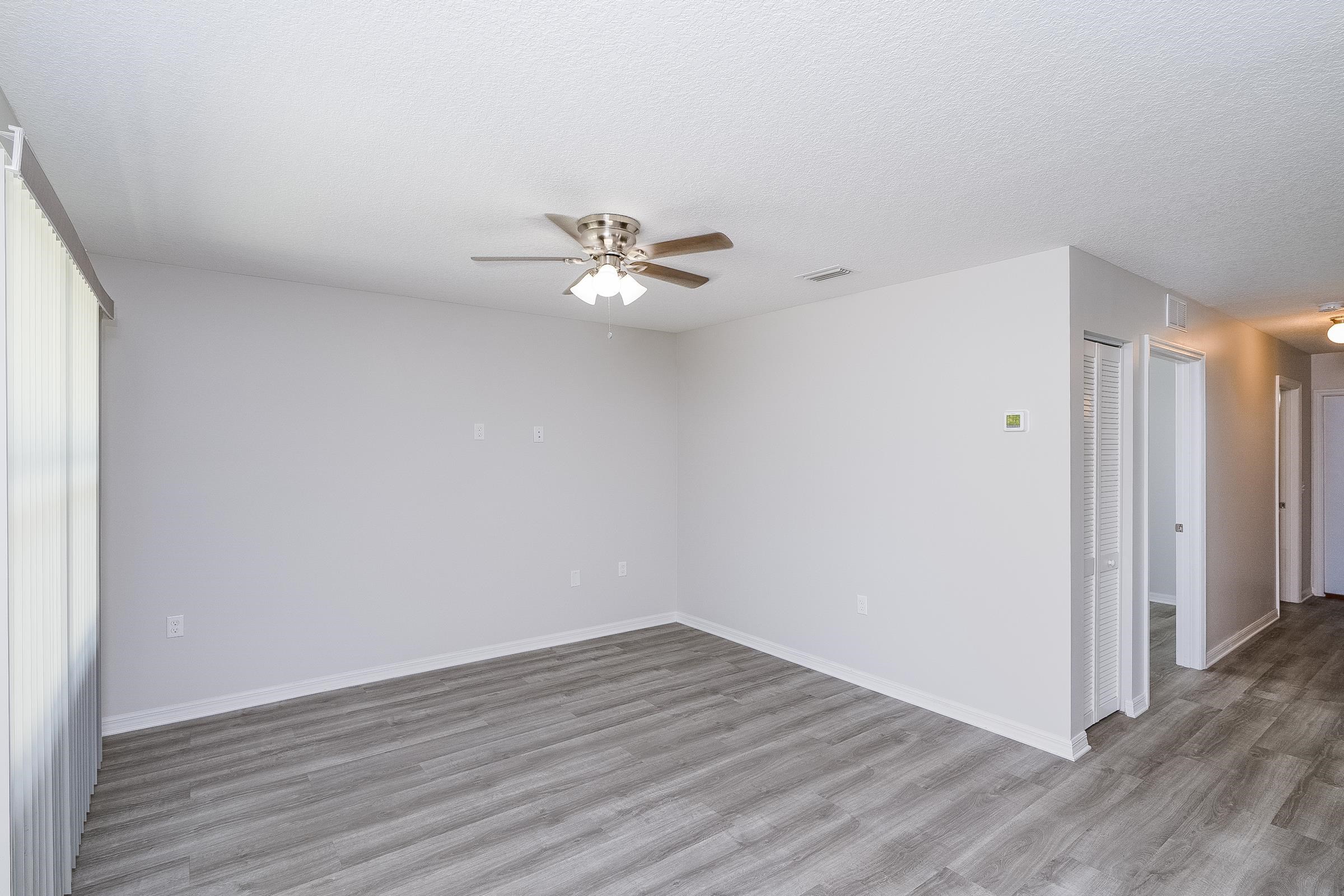 874 Ervin Street St. Augustine, FL 32084 - Photo 17 of 29 a view of a room with wooden floor and a ceiling fan