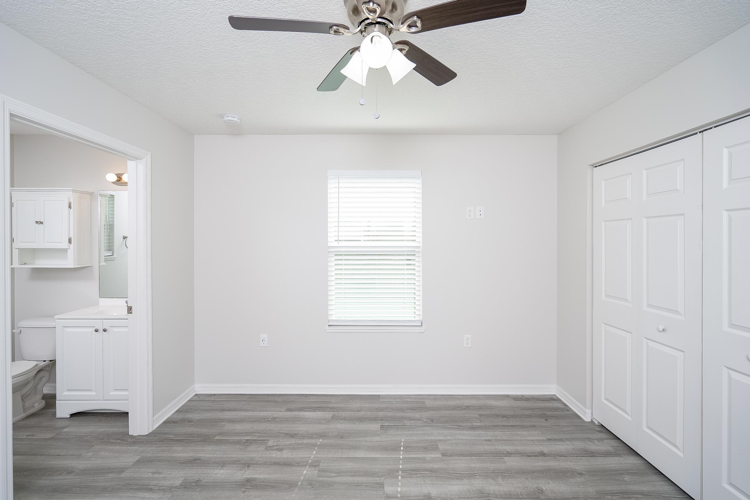 874 Ervin Street St. Augustine, FL 32084 - Photo 19 of 29 a view of an empty room with wooden floor and a window
