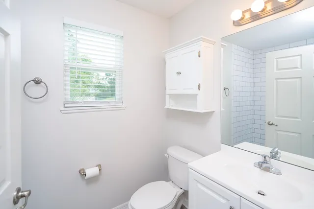 a bathroom with a sink toilet and mirror