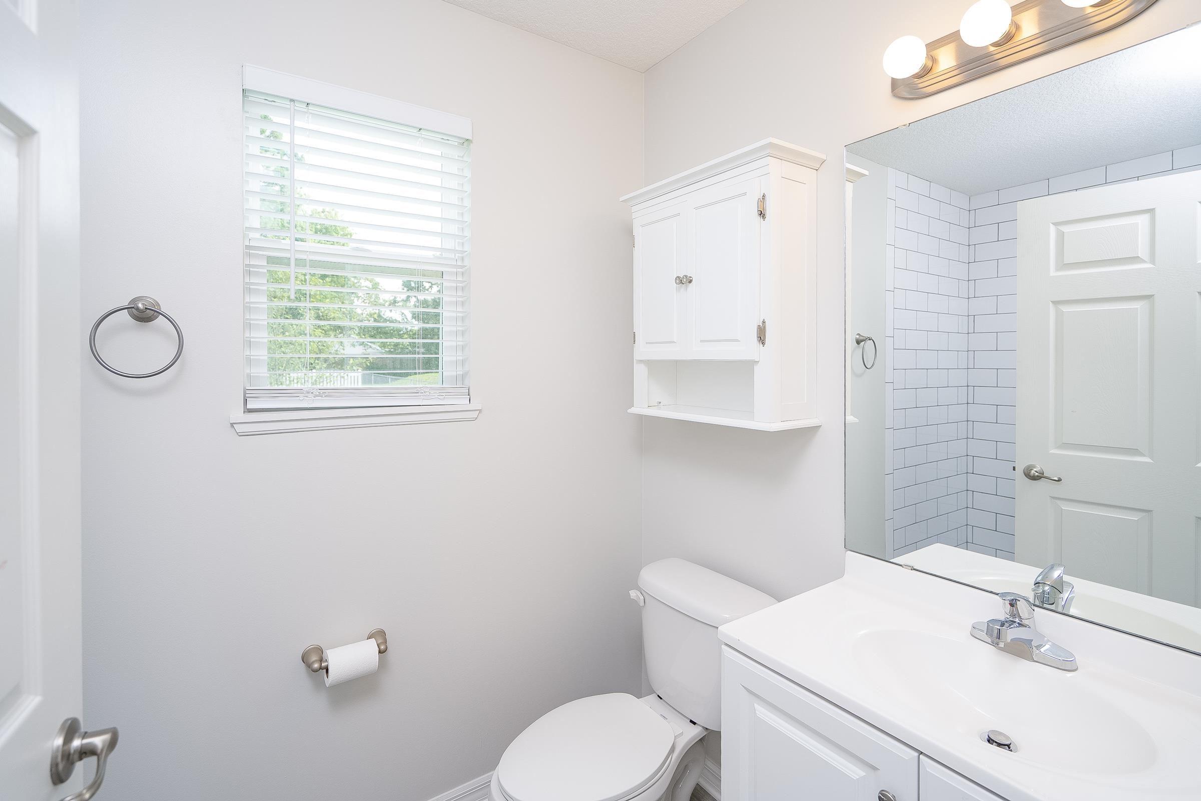 874 Ervin Street St. Augustine, FL 32084 - Photo 21 of 29 a bathroom with a sink toilet and mirror