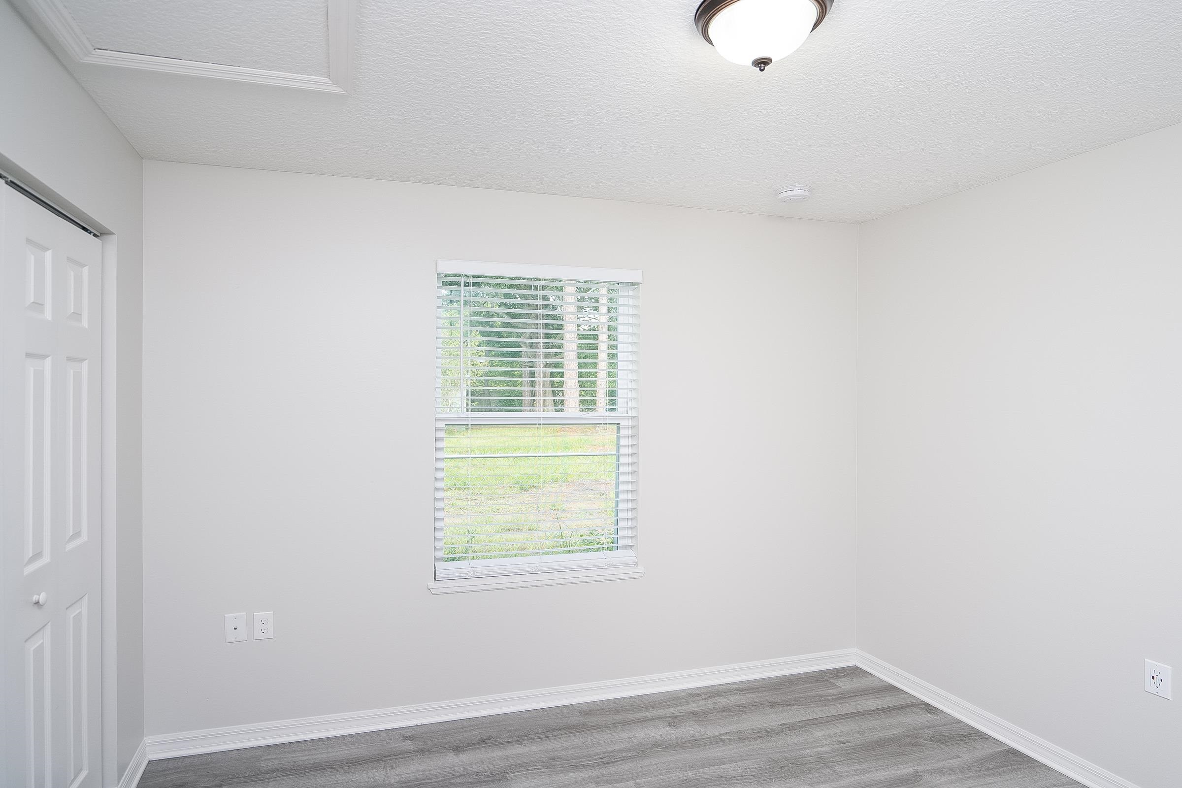 874 Ervin Street St. Augustine, FL 32084 - Photo 23 of 29 a view of an empty room with wooden floor and a window
