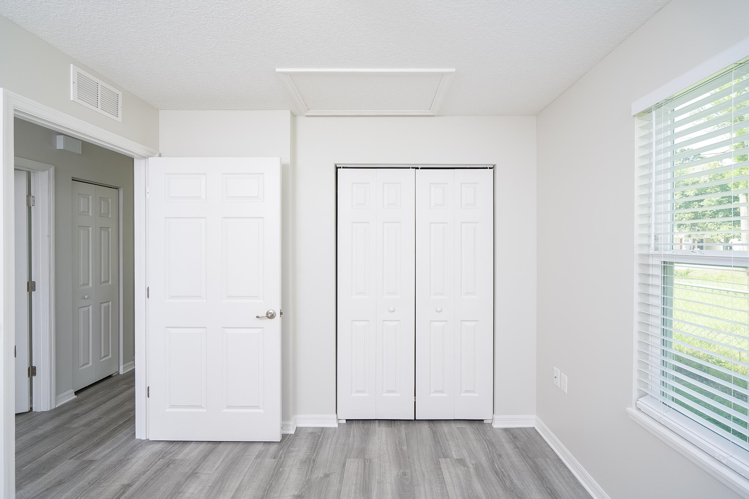 874 Ervin Street St. Augustine, FL 32084 - Photo 24 of 29 an empty room with wooden floor and windows