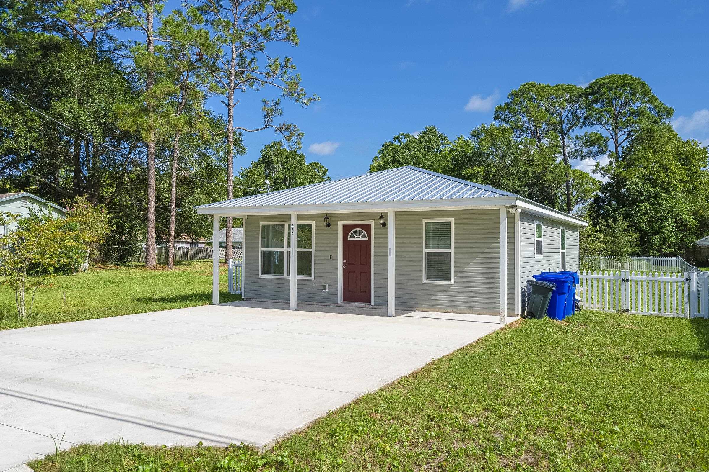 874 Ervin Street St. Augustine, FL 32084 - Photo 3 of 29 a view of a house with a yard and potted plants