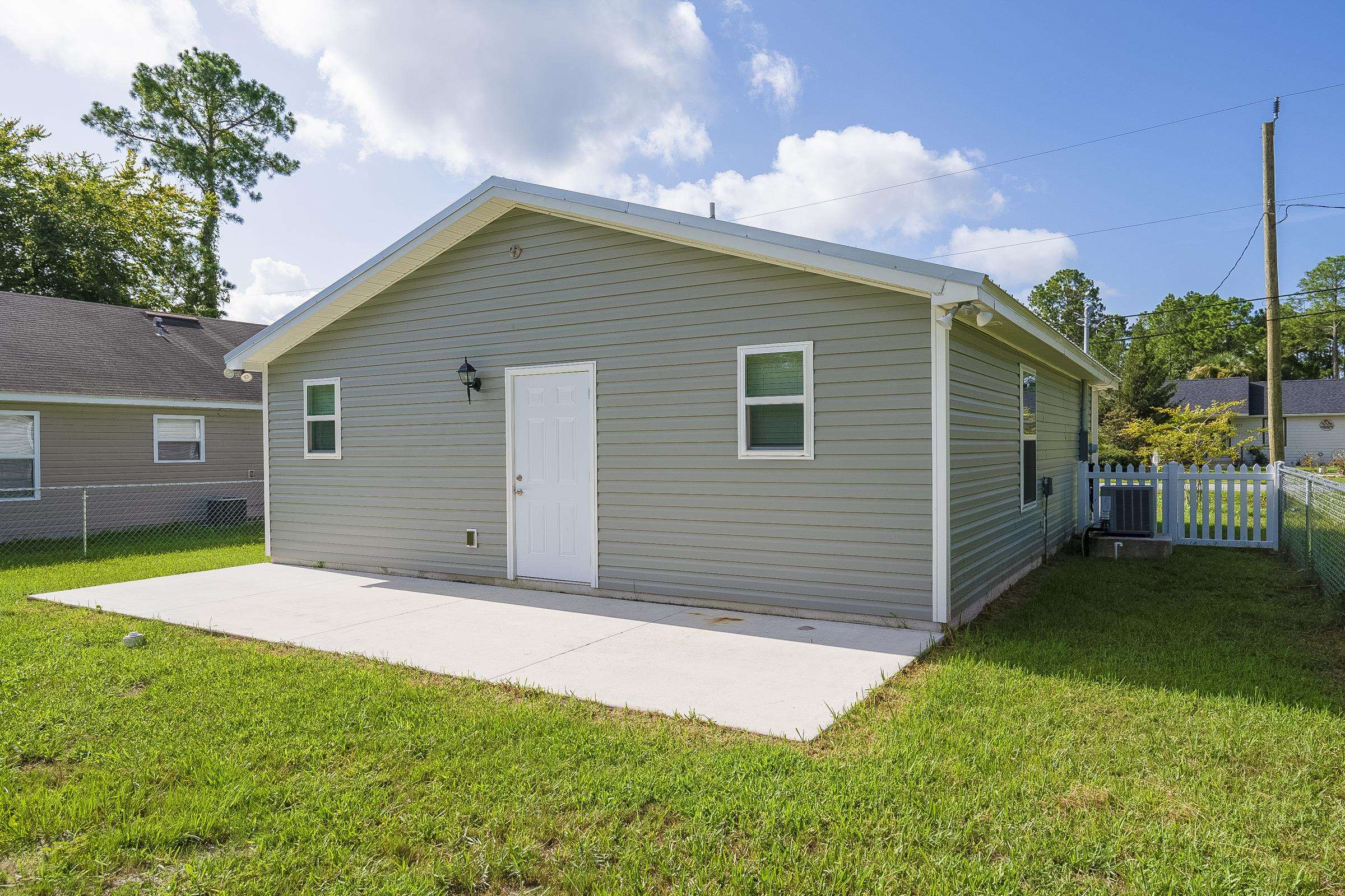874 Ervin Street St. Augustine, FL 32084 - Photo 9 of 29 a backyard of a house with barbeque oven and table and chairs