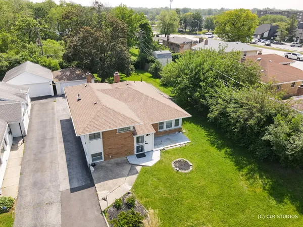 an aerial view of a house with yard swimming pool and outdoor seating