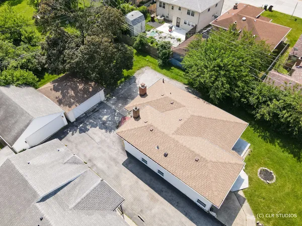 an aerial view of a house with a yard