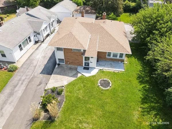 a aerial view of a house with table and chairs