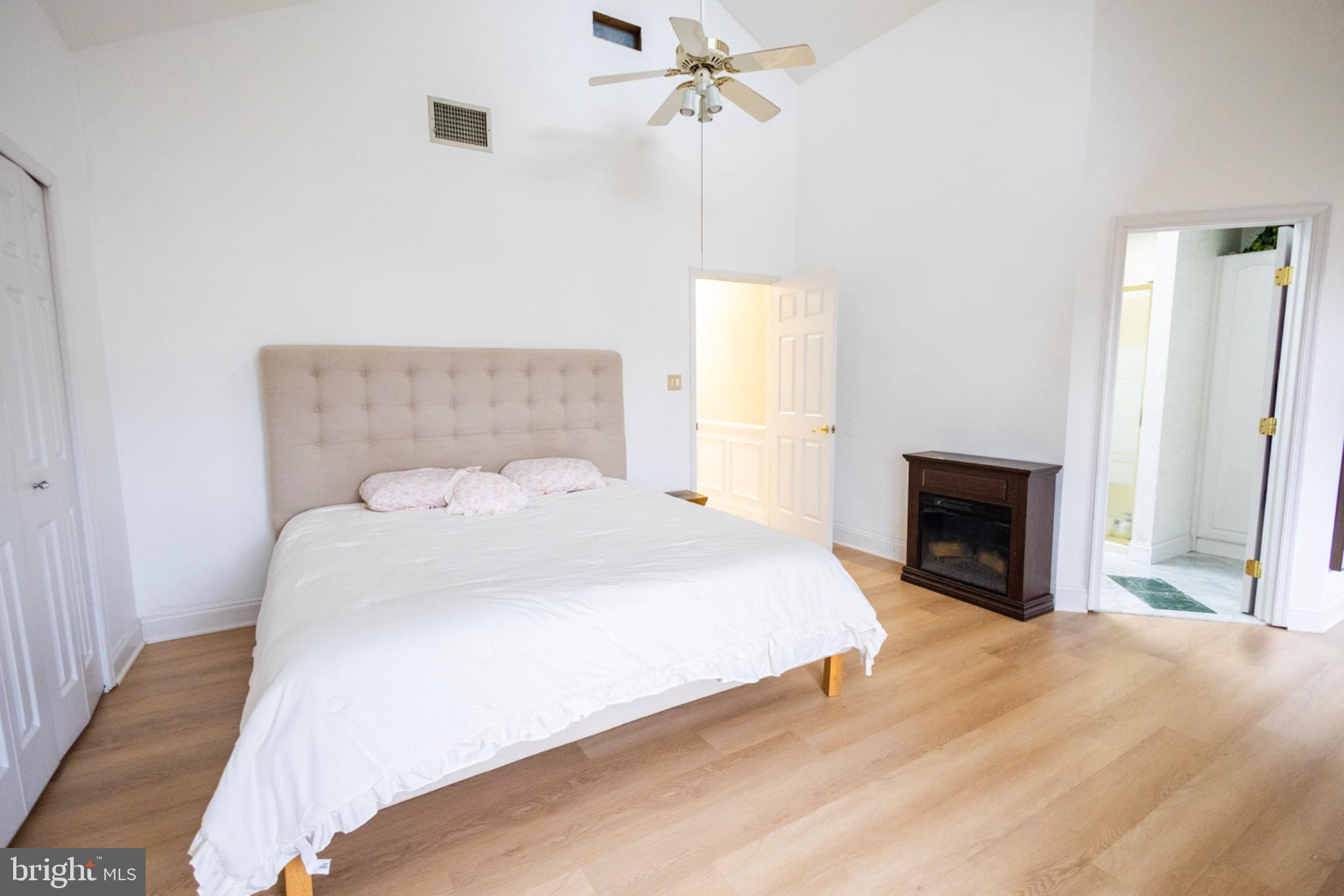 24 Rose Apple Road Levittown, PA 19056 - Photo 14 of 24 a spacious bedroom with a bed and a fireplace