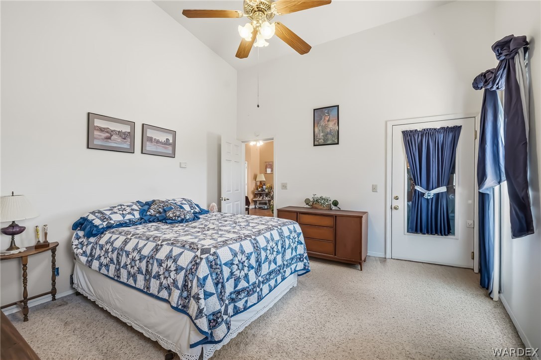 2401 North Stephan Road Kingman, AZ 86401 - Photo 43 of 92 a bedroom with a bed and a chandelier