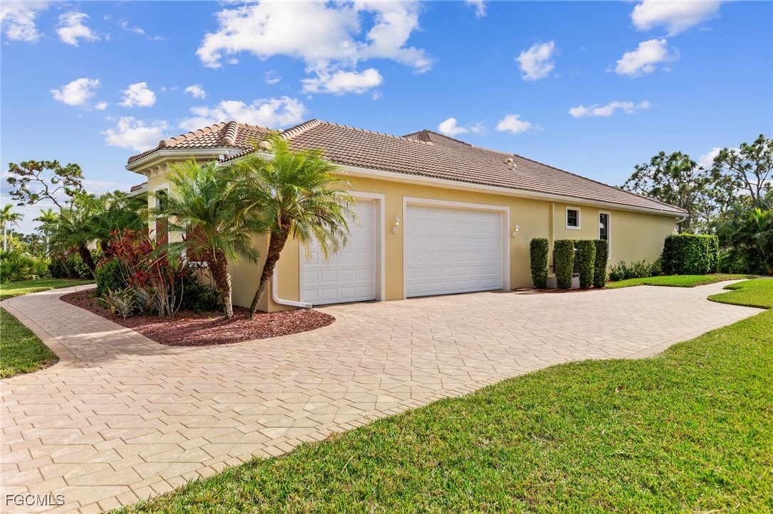 6057 Calusa Rdg Trail Bokeelia, FL 33922 - Photo 37 of 45 a view of yellow house with a yard and potted plants