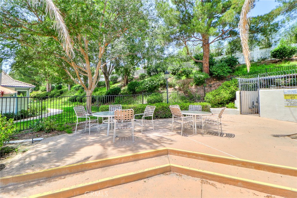 345 Jeremiah Drive, Unit C Simi Valley, CA 93065 - Photo 50 of 66 a view of backyard with table and chairs and large trees