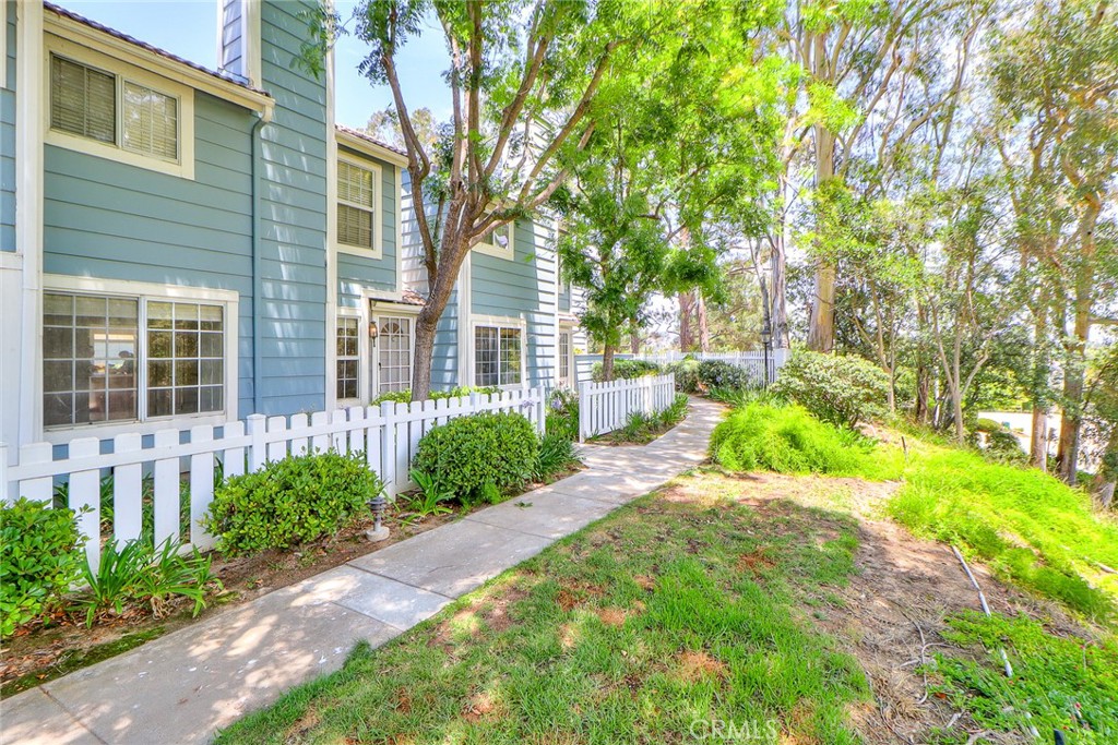 345 Jeremiah Drive, Unit C Simi Valley, CA 93065 - Photo 66 of 66 a view of a brick house with a big yard plants and large trees
