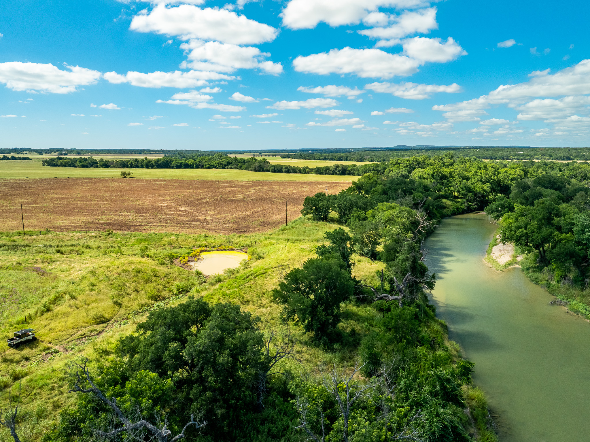 8044 580th Street East Kempner, TX 76539 - Photo 30 of 40 A tranquil river winds through verdant fields and a lush tree line under a vast sky.