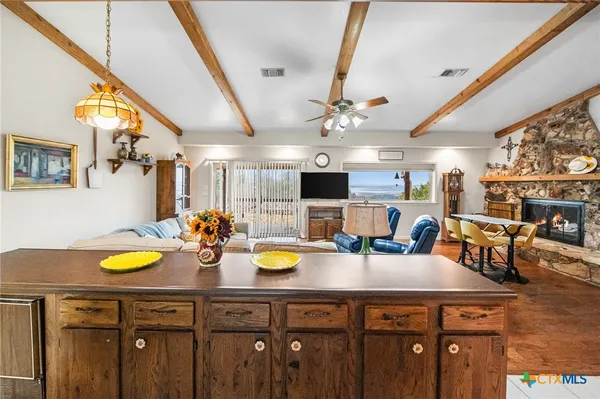 a kitchen with a sink a counter space and living room
