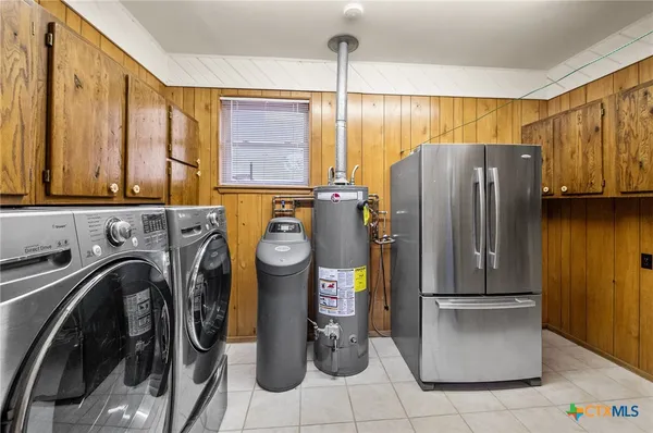 a view of a kitchen with fridge and washer