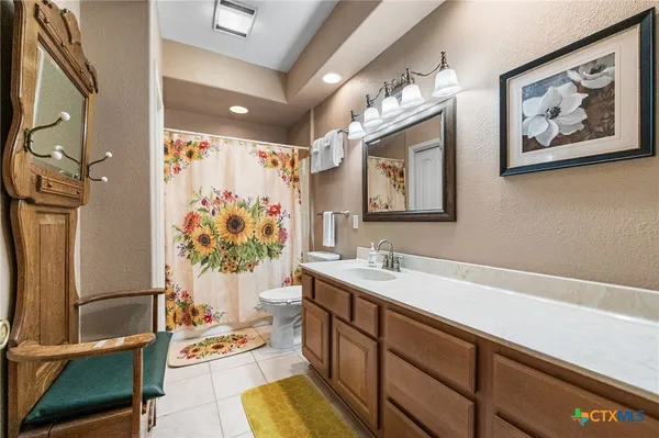 a bathroom with a sink a vanity and a mirror