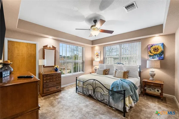 a bedroom with a bed couch and a window