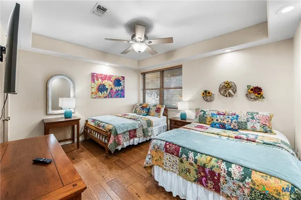 a bedroom with two beds and a table