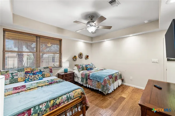 a bedroom with two beds and a chandelier