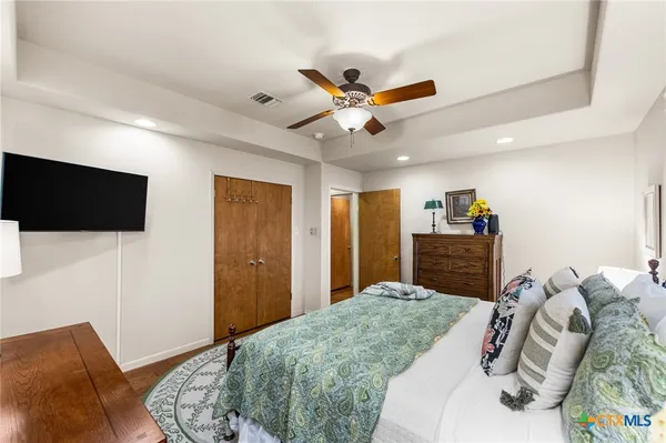 a bedroom with bed and a flat screen tv