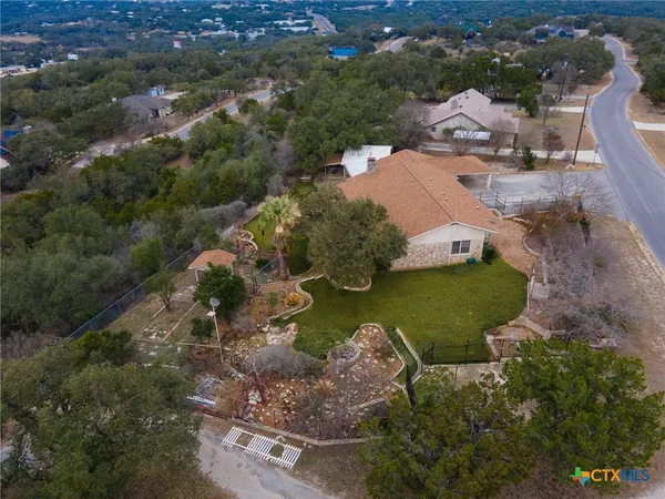 an aerial view of a house with a yard