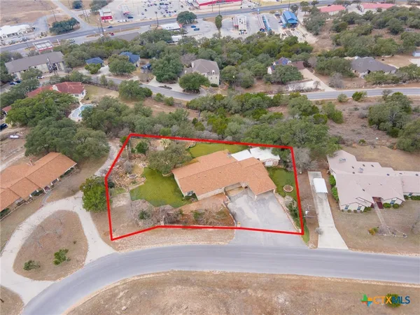 an aerial view of a house with a yard