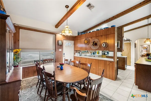 a view of a dining room with furniture and chandelier