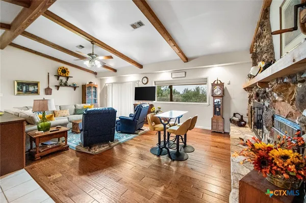 a living room with furniture a dining table and a potted plant