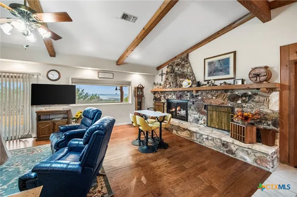 a living room with fireplace furniture and a flat screen tv